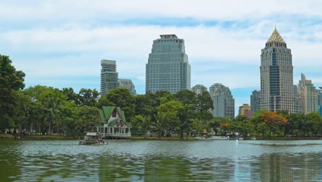 building-in-the-business-district-of-the-city-overlooking-the-green-park-and-lake.-urban-style.-corporate-buildings