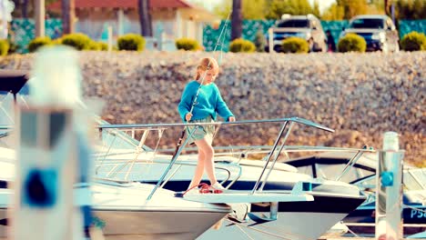 Girl-on-a-yacht-or-a-boat-keeps-the-fishing-rod