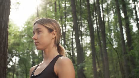 Woman-Daydreaming-in-Forest-on-Sunny-Day