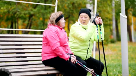 Two-mature-woman-resting-after-scandinavian-walk