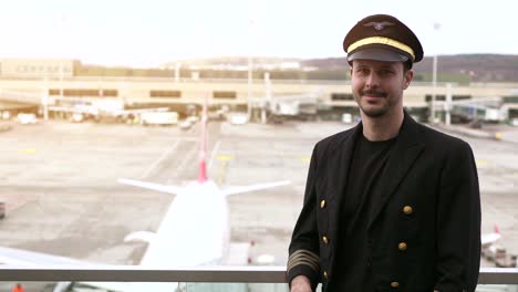 Young-airplane-captain-standing-on-airport