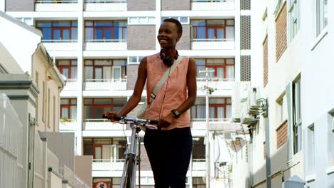 Woman-walking-with-bicycle-in-city-street-4k