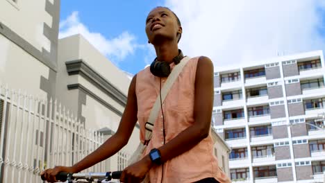 Woman-walking-with-bicycle-in-city-street-4k