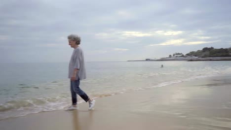 Beautiful-senior-woman-splashing-around-sea-water.