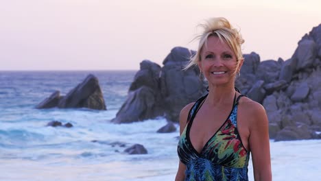 Portait-of-a-beautiful-older-woman-standing-on-the-beach