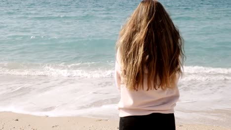 Girl-with-long-ginger-red-hair-enjoying-sea-breeze-against-background-of-seascape.-Sea-breeze-playing-with-hair.