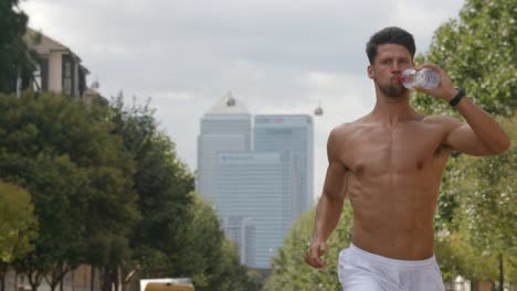 A-young-man-running-though-London-with-City-of-London-behind-him.