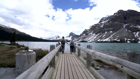 Young-couple-enjoying-nature-at-mountain-lake,-Canada