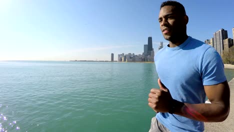 African-American-male-running-along-Chicago-city-shoreline