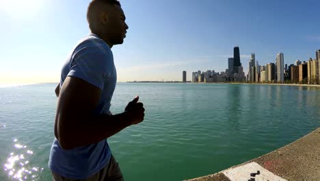 Young-Ethnic-male-running-along-Chicago-city-shoreline