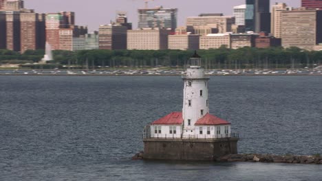 Aerial-shot-the-Chicago-Harbor-Light-lighthouse-with-downtown-Chicago-in-background.