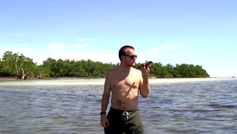 Man-throws-Starfish-into-the-sea