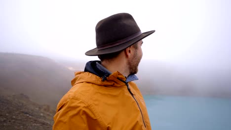 Portrait-of-travel-male-on-top-of-crater-lake-in-Iceland