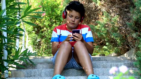 Young-boy-using-smartphone-at-the-oudoor