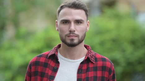 Young-happy-handsome-bearded-man-smiling-in-the-streets-outdoors