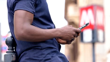 close-up-on-American-african-man's-hands-typing-on-smartphone--technology,-communication