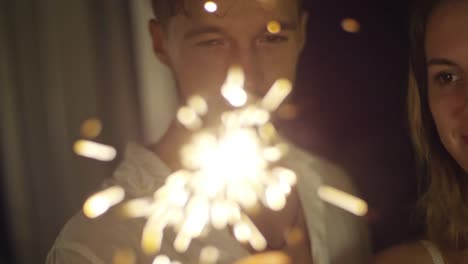 Caucasian-Couple-Looking-at-Sparkler-Flames