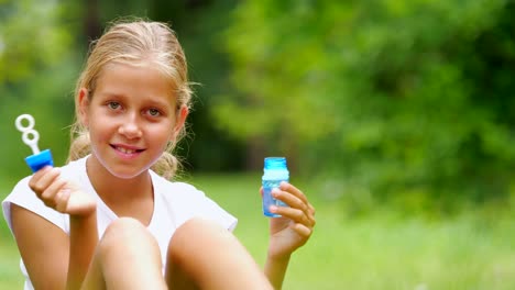 Little-girl-playing-with-soap-bubbles-outdoor.-Slow-motion.