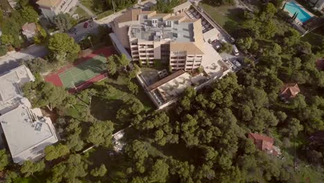 Aerial-view-of-a-residential-building,-surrounded-by-trees-in-Greece.