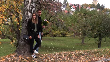 Young-brunette-girl-is-waiting-for-a-guy-with-flowers-on-a-date