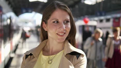 Young-adult-woman-enjoying-her-day-in-the-city-and-at-the-train-station