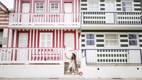 Woman-with-stretched-out-hand-sitting-near-buildings