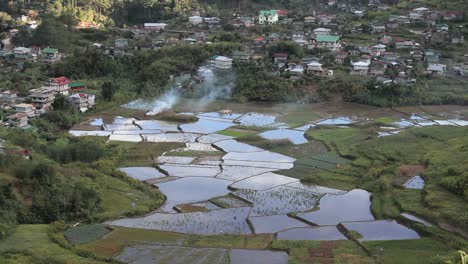 Rice-terraces-with-smoke-from-above-in-The-Philippines