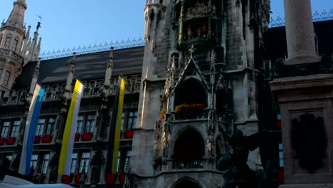 Flags-wave-on-gothic-city-hall-building