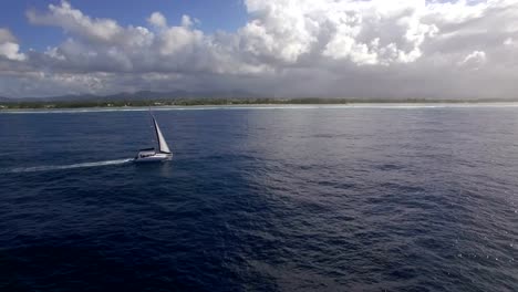 Sailing-yacht-and-island-coast,-aerial-shot