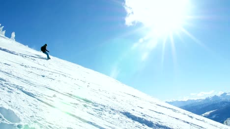 Person-snowboarding-on-snowy-mountain