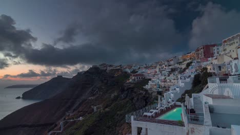 sunset-sky-santorini-island-illuminated-oia-town-bay-hill-panorama-4k-time-lapse-greece