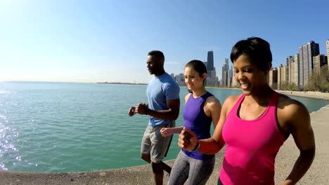 Multi-Ethnic-American-friends-speed-walking-by-shoreline