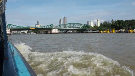 View-on-Bangkok-from-moving-boat,-public-transport-on-Chao-Praya-river.-Thailand.