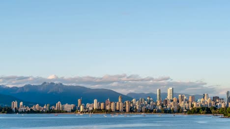 high-rise-buildings-of-modern-seaside-city,-yachts-and-ships,-from-the-ocean-side-against-the-background-of-mountains