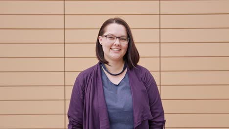 Young-Lady-Smiling-against-a-Beige-Background