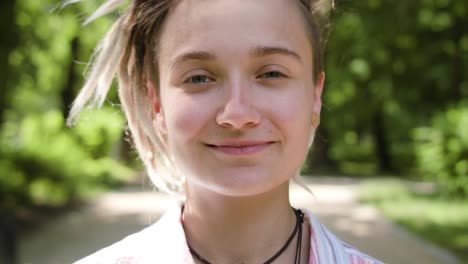 Young-Lady-with-Modern-Hairstyle-Smiling-Outdoors