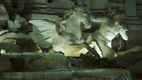 Night-view-to-Fountain-Di-Trevi,-Rome,-Italy.-Details-of-the-most-beautiful-and-famous-fontana-in-the-world