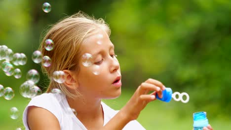 Little-girl-playing-with-soap-bubbles-outdoor.-Slow-motion.