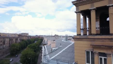 Drone-flight-near-the-old-style-tower-with-factory-on-the-background