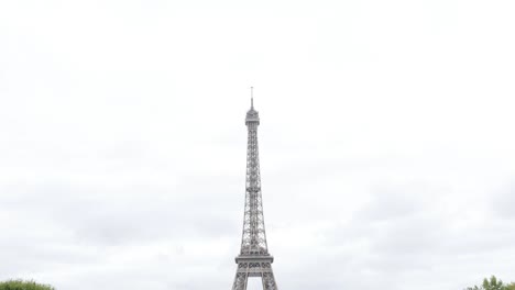 Slow-tilt-on-Eiffel-tower-lattice-construction-in-front-of-cloudy-sky-France-Paris-4K