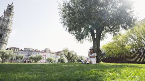 Woman-relaxing-on-lawn-in-sunny-day