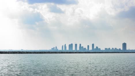 Distant-view-of-city-at-waterfront,-Toronto,-Ontario,-Canada