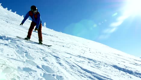 Person-snowboarding-on-snowy-mountain