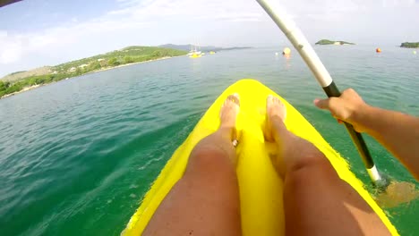 Kayaking-on-calm-green-water,-4K-UHD-POV