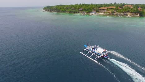 Aerial:-Filipino-Boat-Moving-In-The-Beautiful-Sea-In-Moalboal,-Cebu.