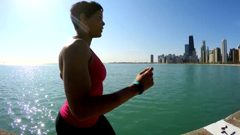 Ethnic-female-running-in-sportswear-by-Chicago-shoreline