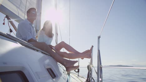 Young-couple-relax-on-sailboat-together.