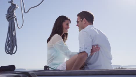 Young-couple-sitting-on-sailboat-together.