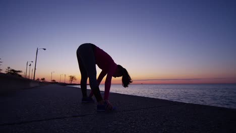 Hispanic-Caucasian-female-silhouette-stretching-by-Lake-Michigan