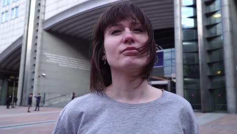 tourist-lady-walks-and-looks-at-attractions-near-the-European-Parliament-in-Brussels.-Belgium.-slow-motion.dolly-zoom-effect